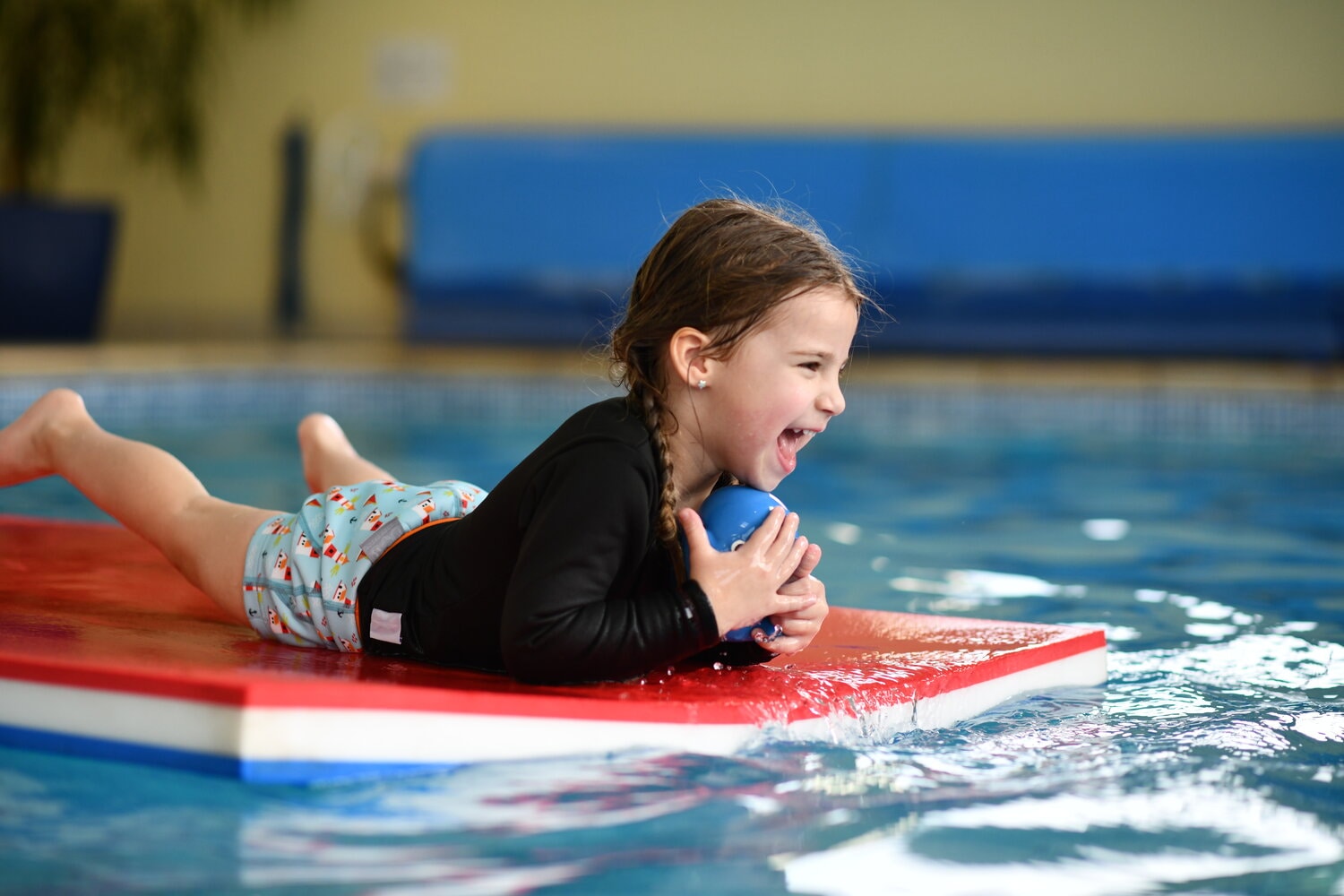 water babies toddler on a mat in the swimming pool
