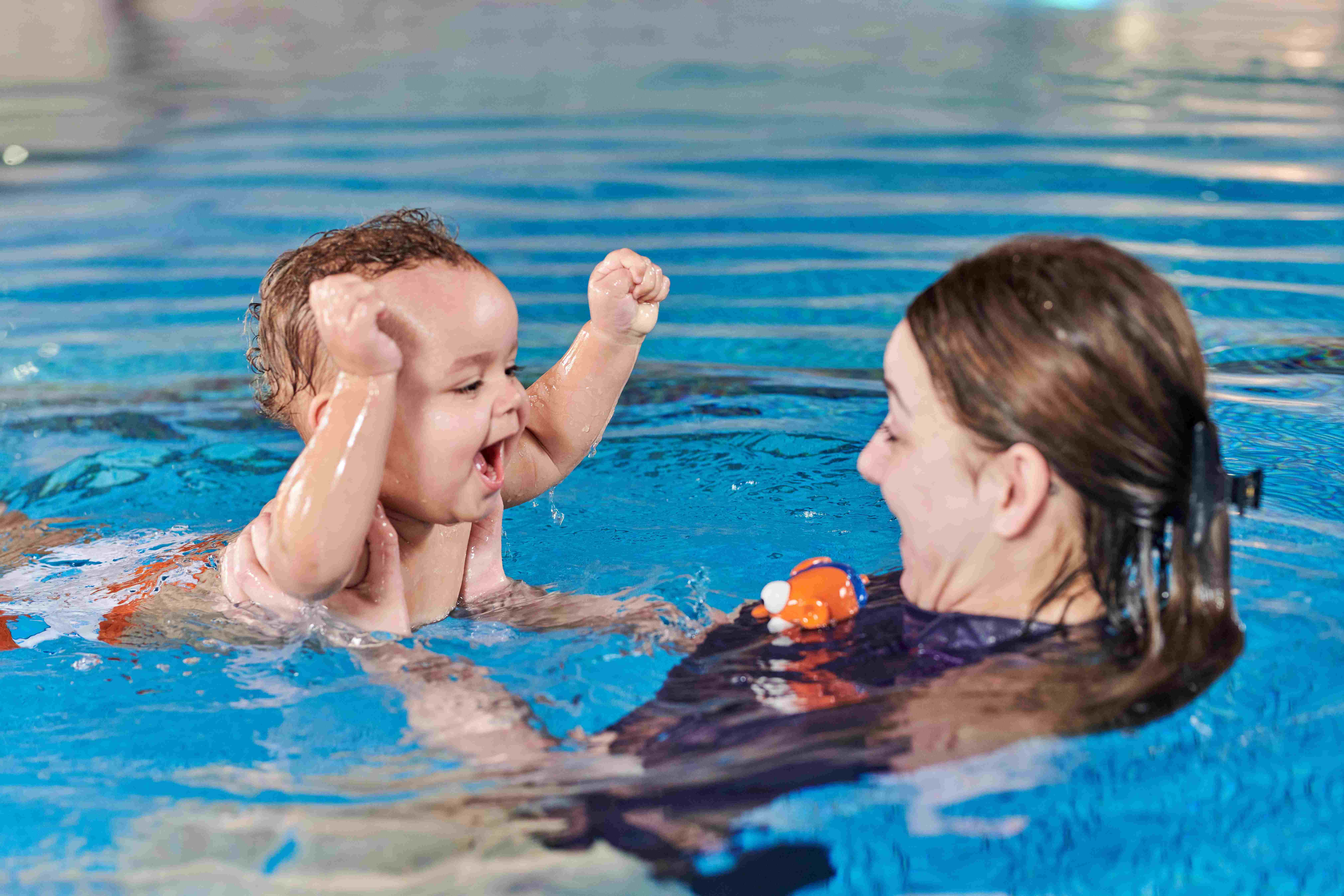 baby and teacher in the pool