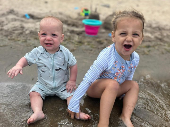 two children playing in the sand